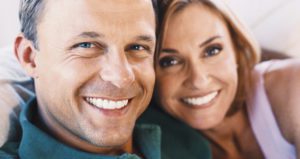 Married couple posing together for a picture both smiling 1