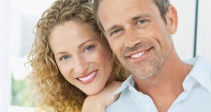 Married couple posing together for a picture both smiling