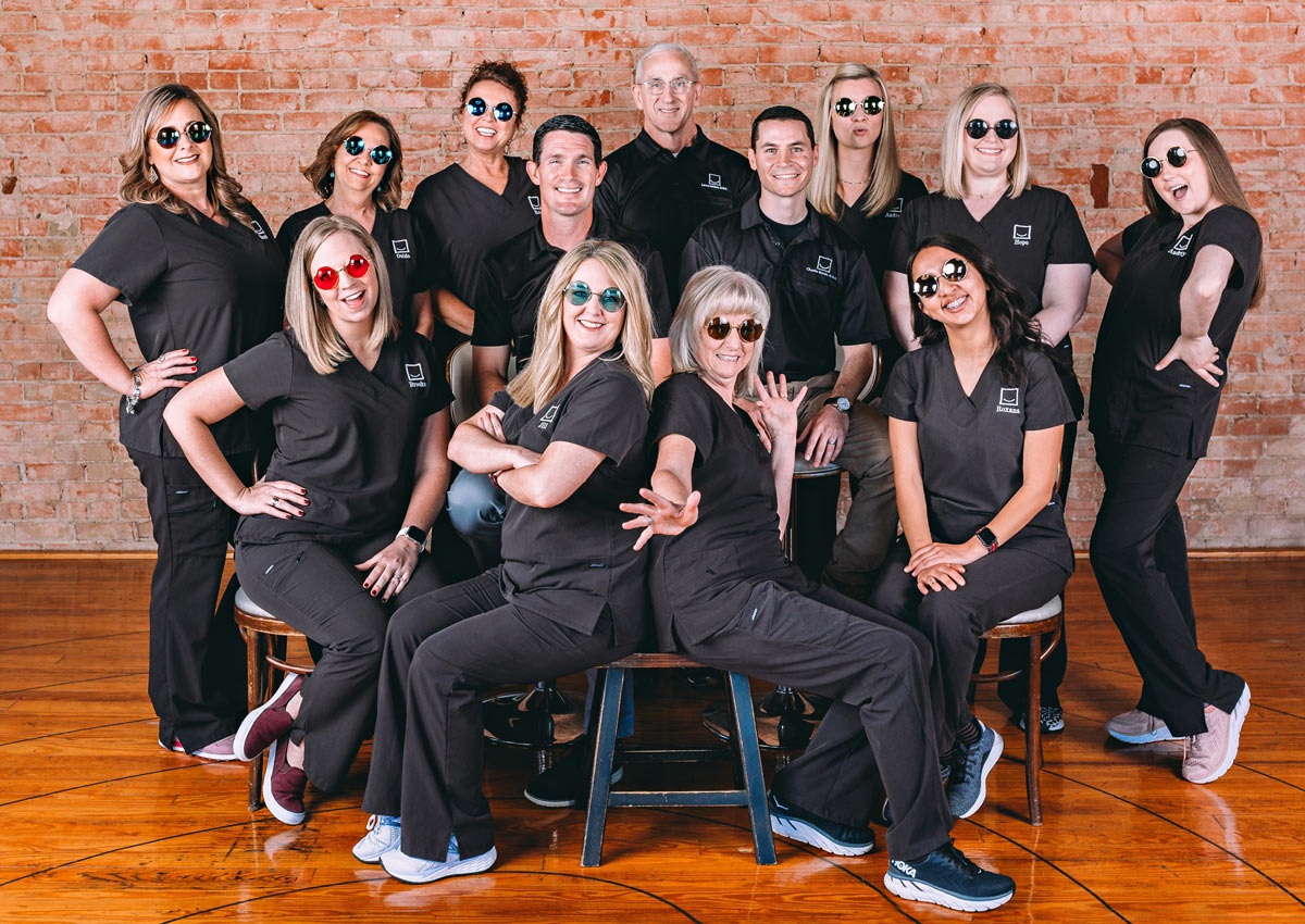All Smiles Jacksonville team is all smiles with round sunglasses on