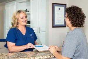friendly dental receptionist speaking with patient