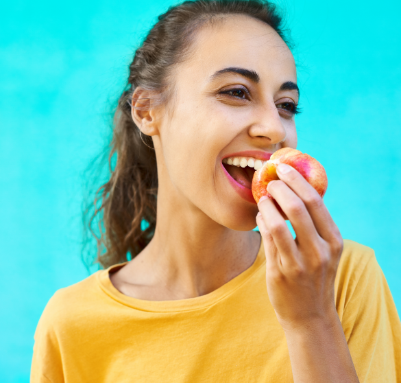Woman biting into a fresh apple.